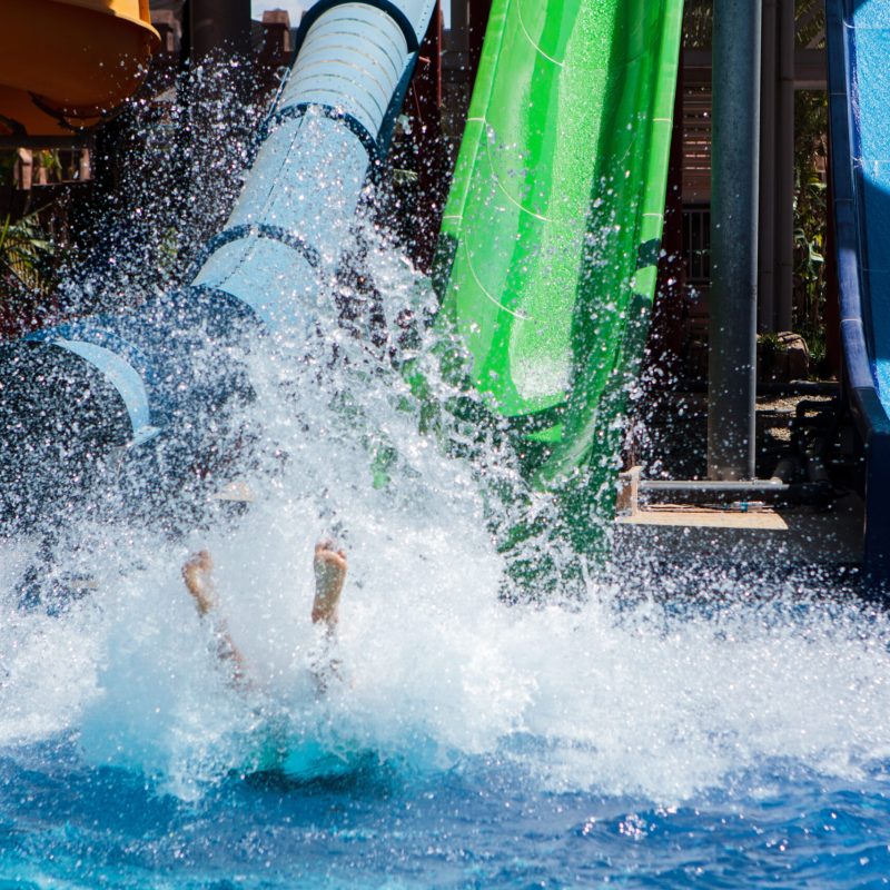 Colourful plastic slides in aquapark near the pool